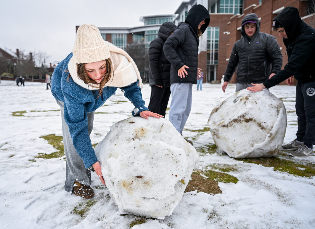 Students play in the snow Monday, Jan. 15, 2024 on Chamberlain Field.