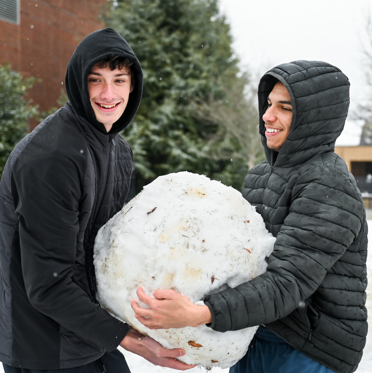 Students play in the snow Monday, Jan. 15, 2024 on Chamberlain Field.