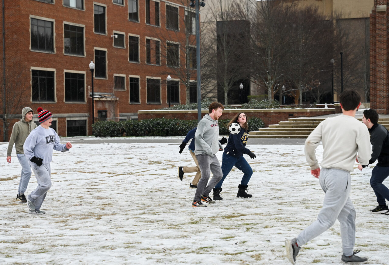 Students play in the snow Monday, Jan. 15, 2024 on Chamberlain Field.