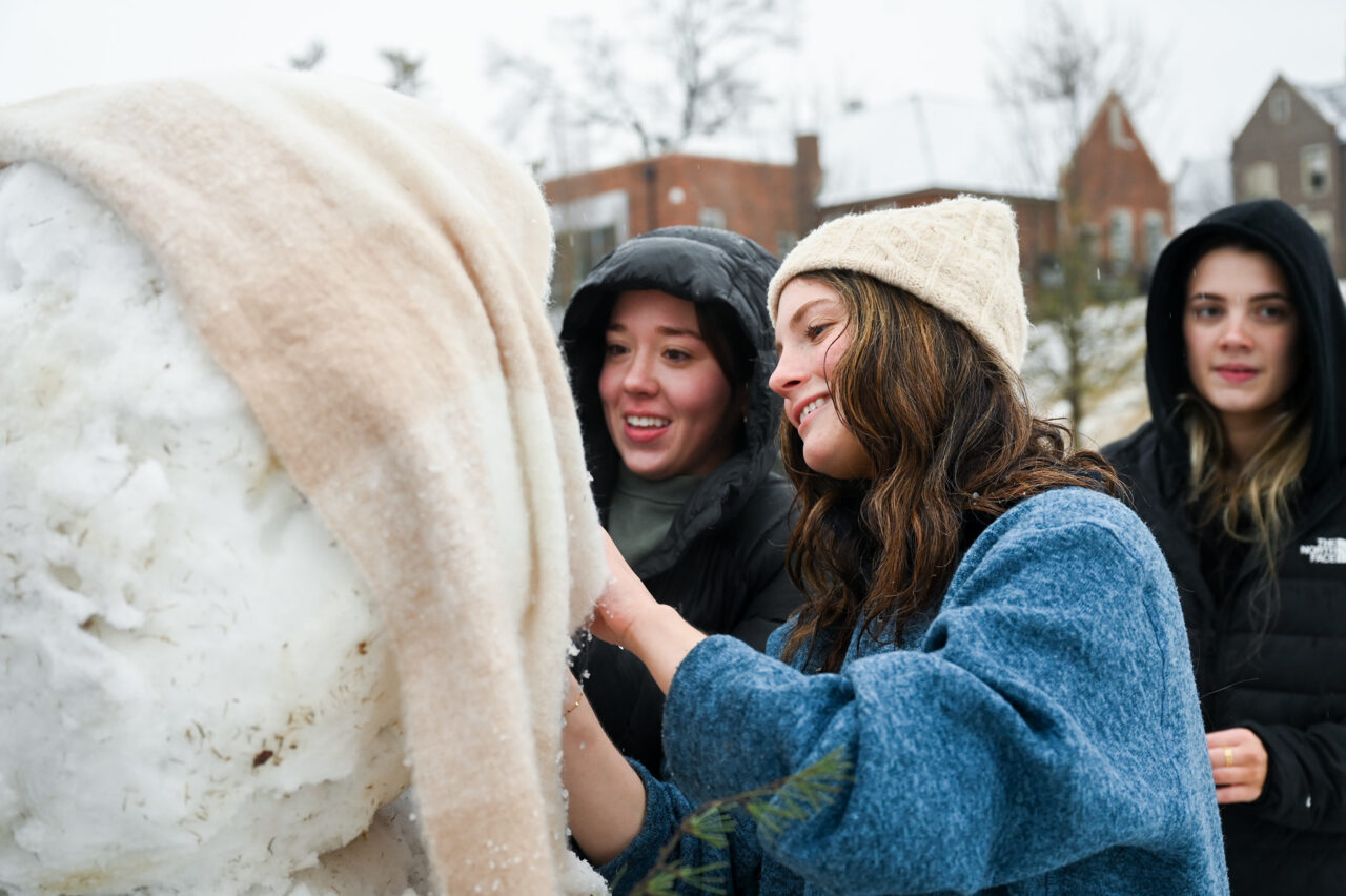 Students play in the snow Monday, Jan. 15, 2024 on Chamberlain Field.