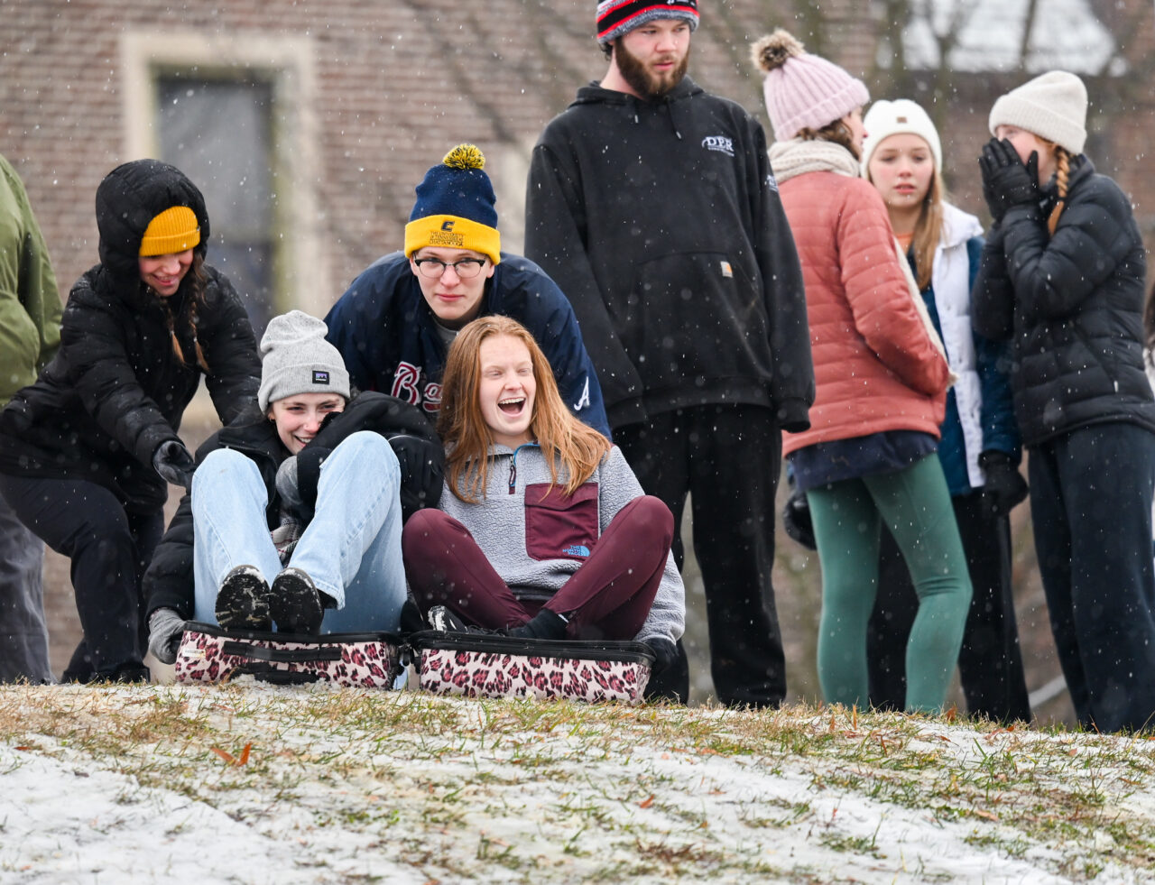Students play in the snow Monday, Jan. 15, 2024 on Chamberlain Field.