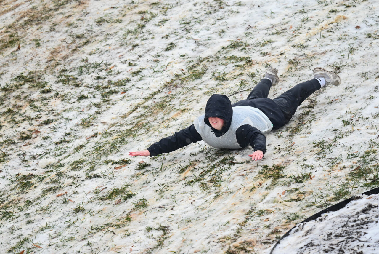 Students play in the snow Monday, Jan. 15, 2024 on Chamberlain Field.
