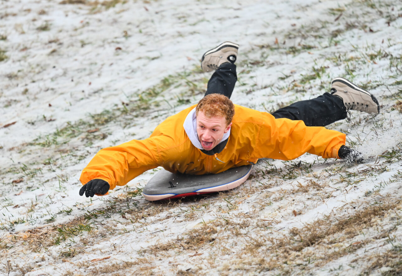 Students play in the snow Monday, Jan. 15, 2024 on Chamberlain Field.