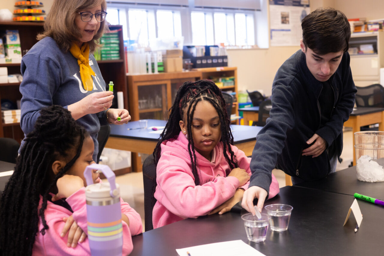 Dr. Stephanie Philipp and UTC student Colin Whitlock, who is pursuing a bachelor's degree in biology STEM education, work with middle school students from Coretta Scott King Young Women's Leadership Academy. Photo by Peyton Schultz.