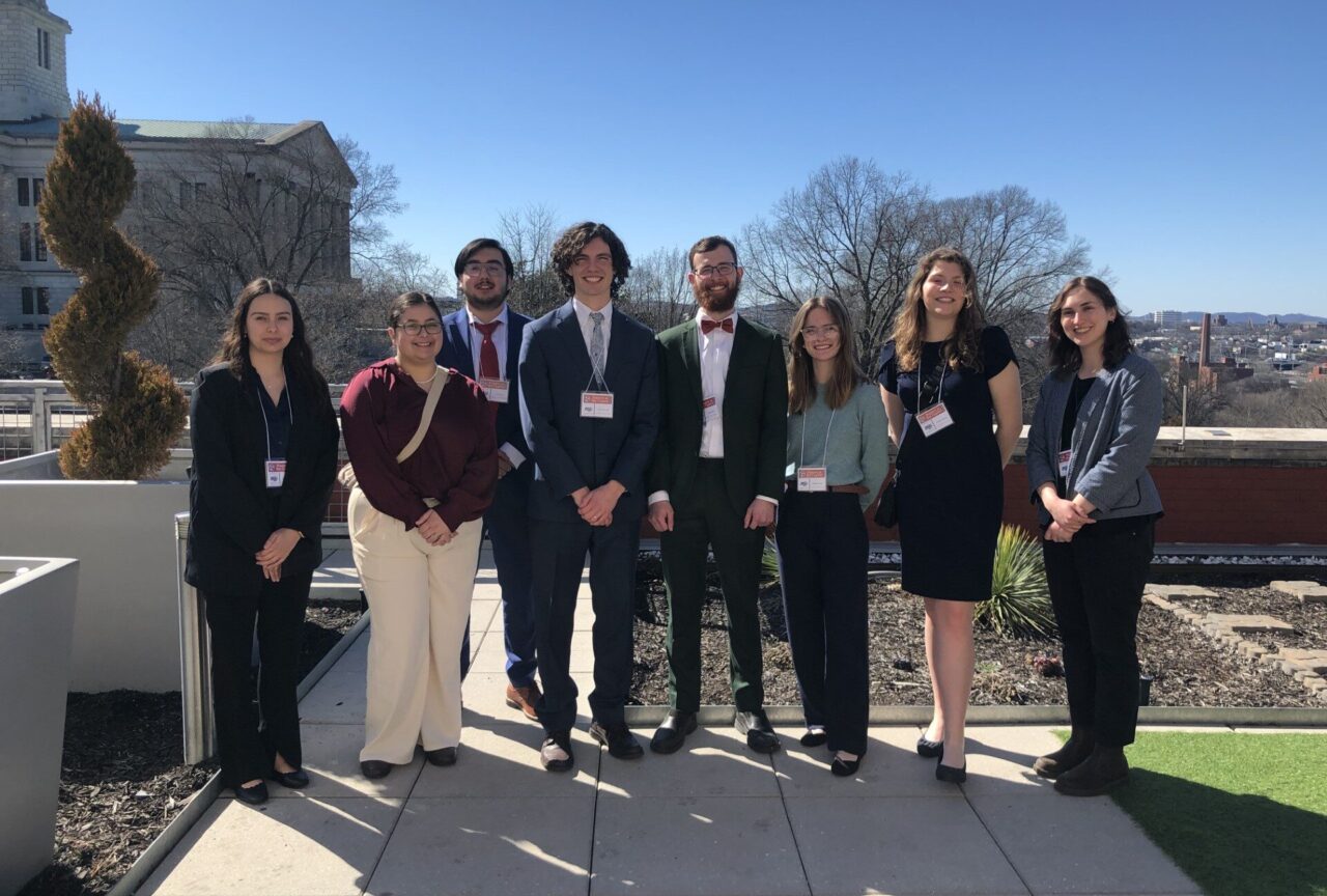 Posters at the Capitol research presenters Amanda Lesswing, left, Meredith Grant, Juan Peña, Ward Metcalfe, Nathanael Moore, Gillian Morton, Christina Harris and URaCE Program Administrator Caitlin Kelley. Photo courtesy of Caitlin Kelley.