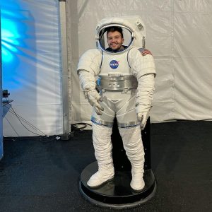 Photo of Ian Tidwell standing in an astronaut space suit