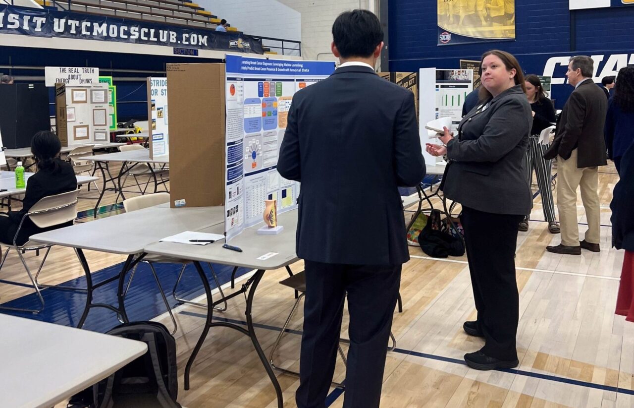 Dr. Rachael Davis judges Joshua Kim's project in Maclellan Gym. Photo by Peyton Schultz.