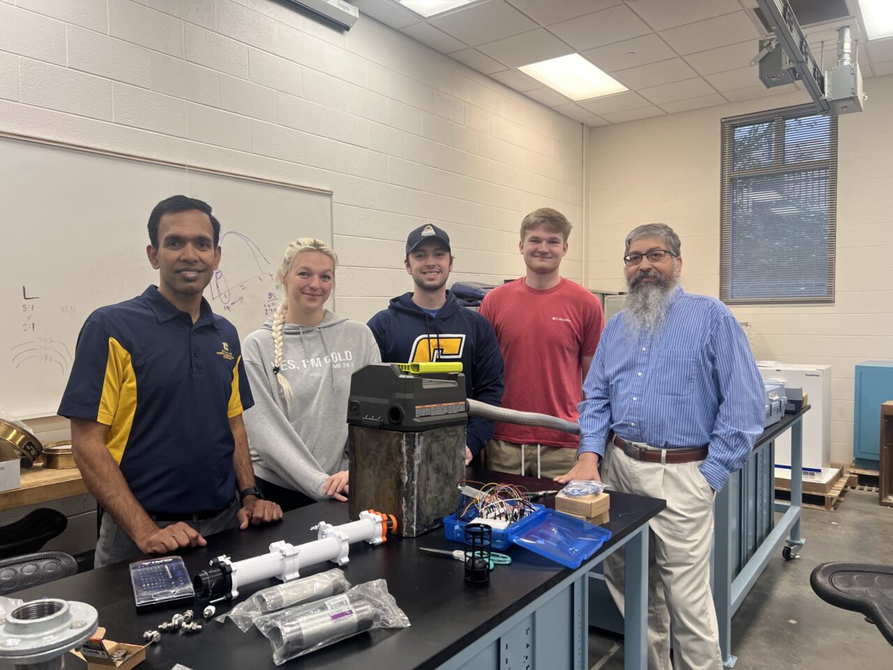 Dr. Jejal-Reddy Bathi, left, and students Kara Kimes, David Brown, Landon Norman and Professor of Mechanical Engineering Kidambi Sreenivas with the microplastics sampling device.