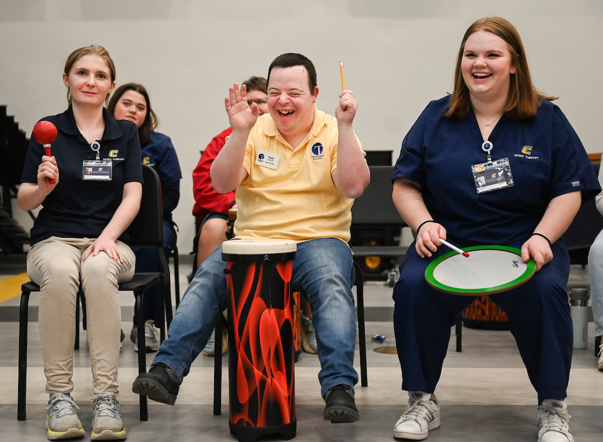 Music therapy students lead students from Trousdale School in a music lesson in the Fine Arts Center band room. Photo by Angela Foster.