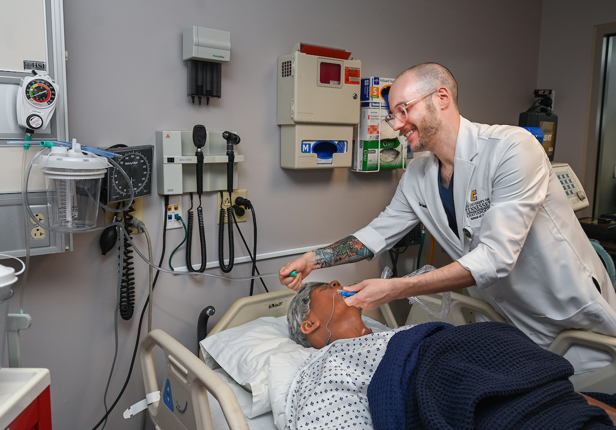 Dr. Chris Doneski performs an intubation on HAL, the School of Nursing's new simulator. Photo by Angela Foster.