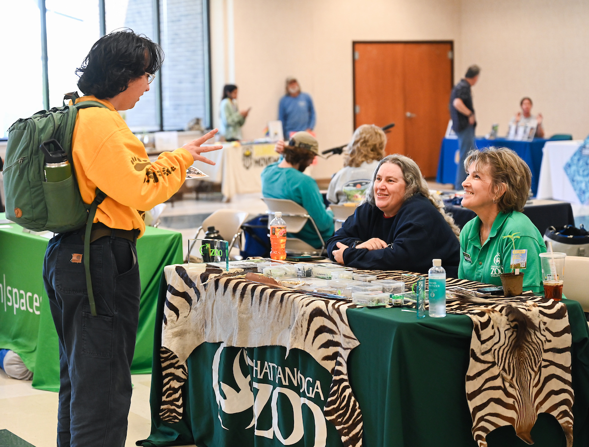 A student talks with representatives from the Chattanooga Zoo at the Earth Day Environment and Sustainability Showcase in the University Center Chattanooga Room. Photo by Angela Foster.