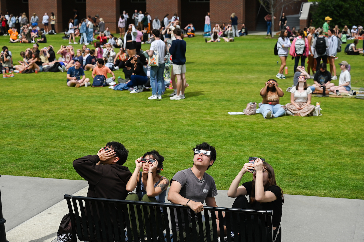 Students watch the eclipse Monday, April 8, 2024 on Chamberlain Field.