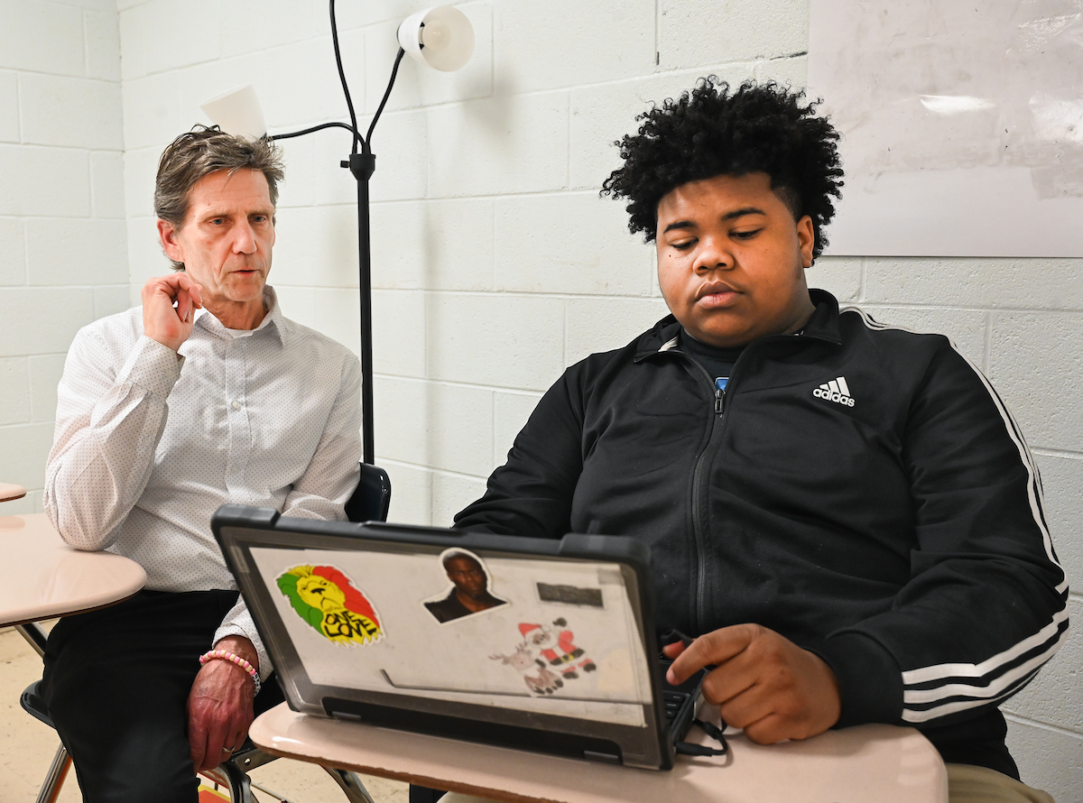 Dr. Hunter Huckabay works with GEAR UP students at The Howard School in Chattanooga. Photo by Angela Foster.