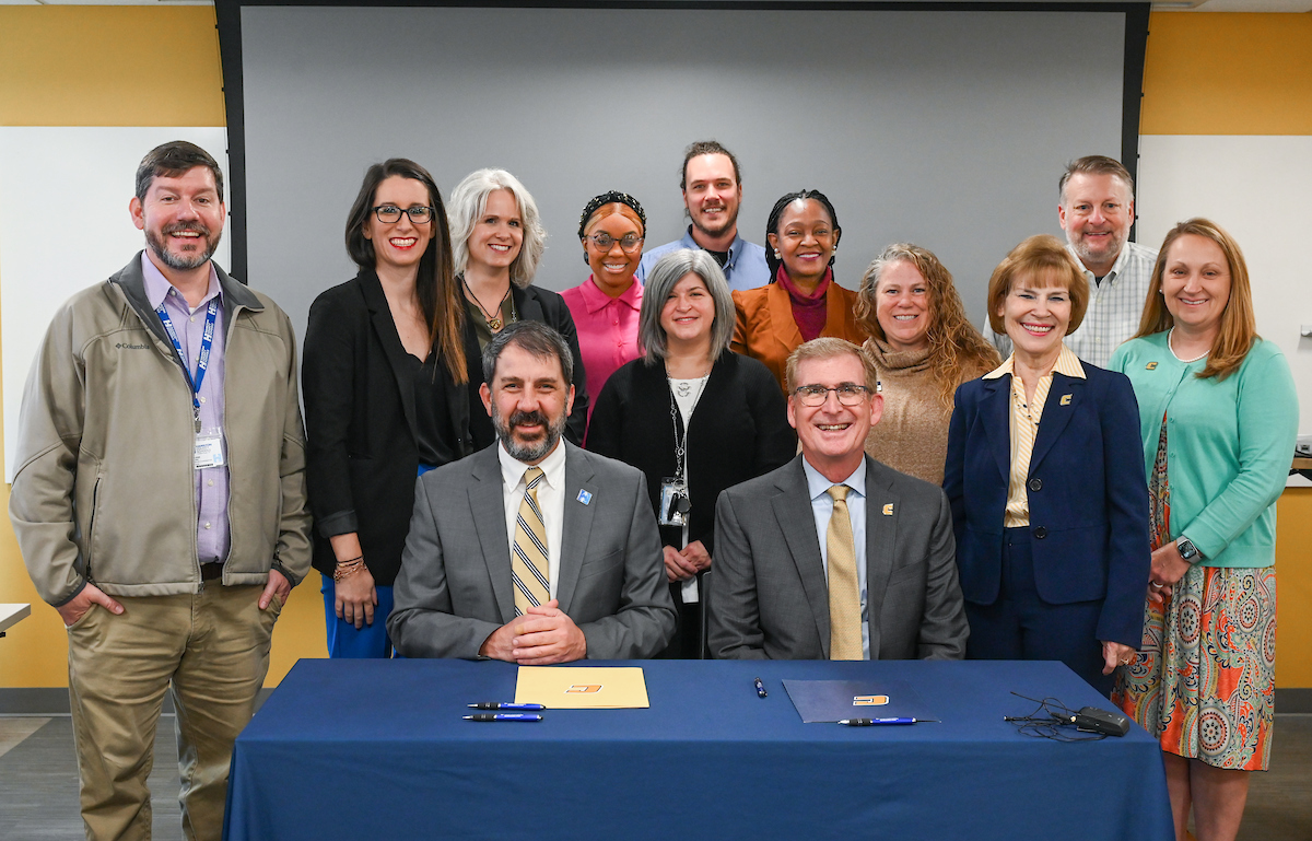 Hamilton County Schools Superintendent Justin Robertson, front row left, UTC Chancellor Steven Angle and representatives from UTC, Hamilton County School and Tyner Academy at the MOU signing ceremony.