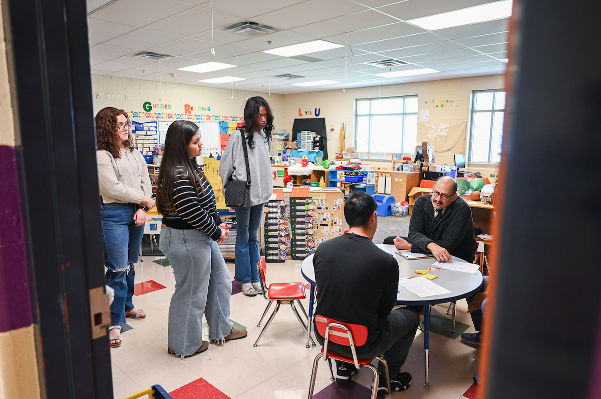 UTC students Caroline Colvin, left, Aracely Angel and Bradley Jellow observe interpreter Gabriel Negrete Regagnon Thursday, March 28, at Orchard Knob Elementary School.