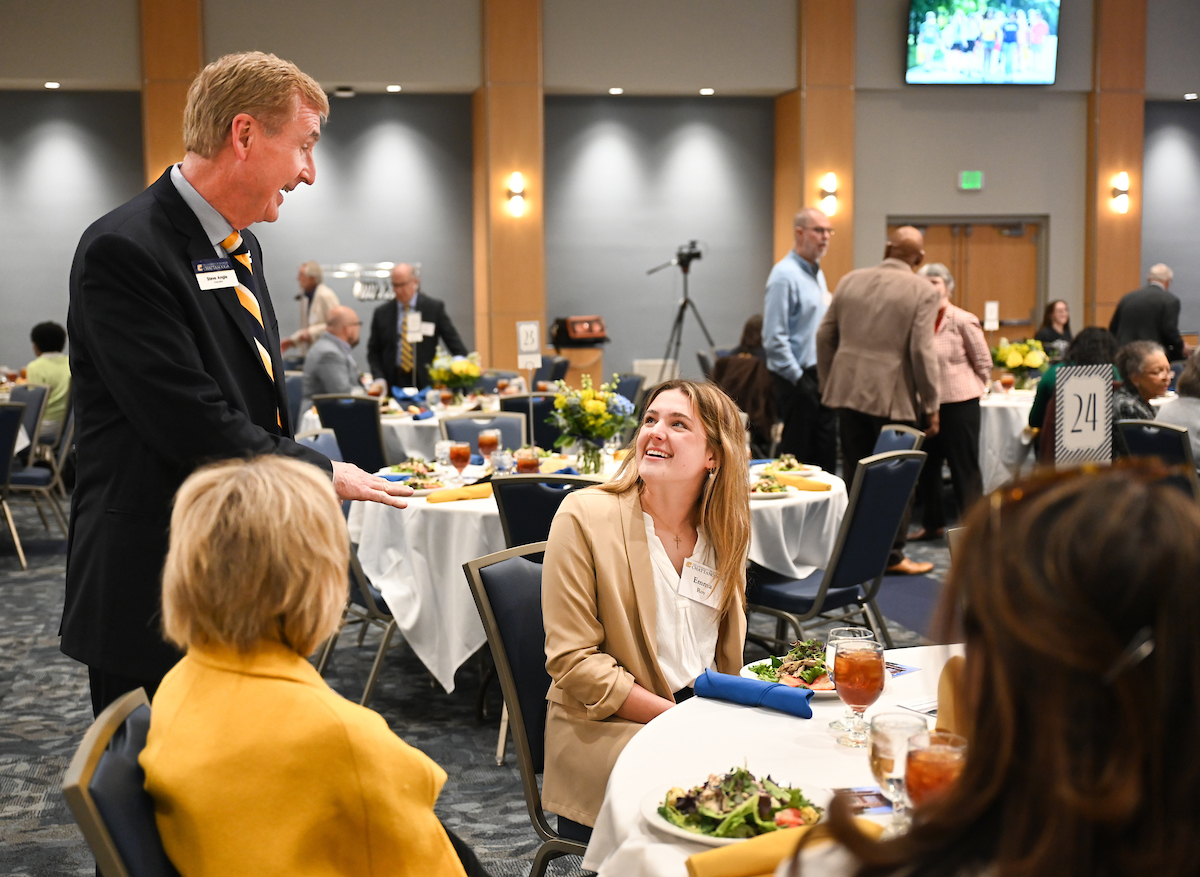UTC Chancellor Steven R. Angle talks to Emma Roy at the University's annual Scholarship Luncheon.