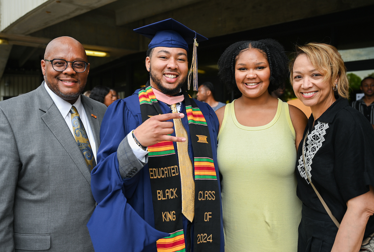 The Freeman family—Yancy Sr., Yancy Jr., Camille and Rafielle—pose after the UTC Graduate School commencement ceremony on Friday, May 3, 2024, in McKenzie Arena.