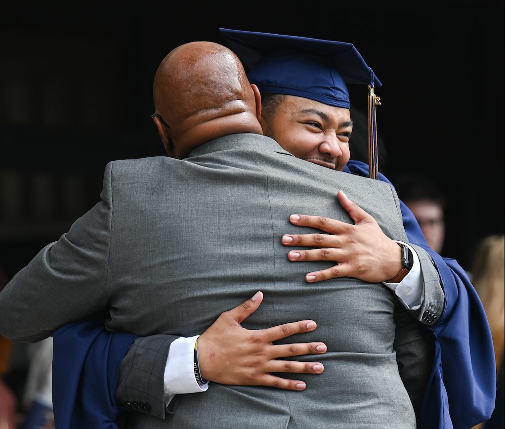 Yancy Freeman Jr. receives a hug from his father, UT Martin Chancellor Yancy Freeman Sr., after Friday's Graduate School commencement. Photo by Angela Foster.