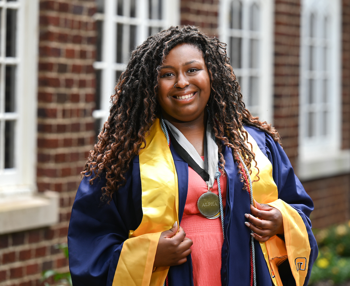 Madison Cothern displays her Alpha Society medal.