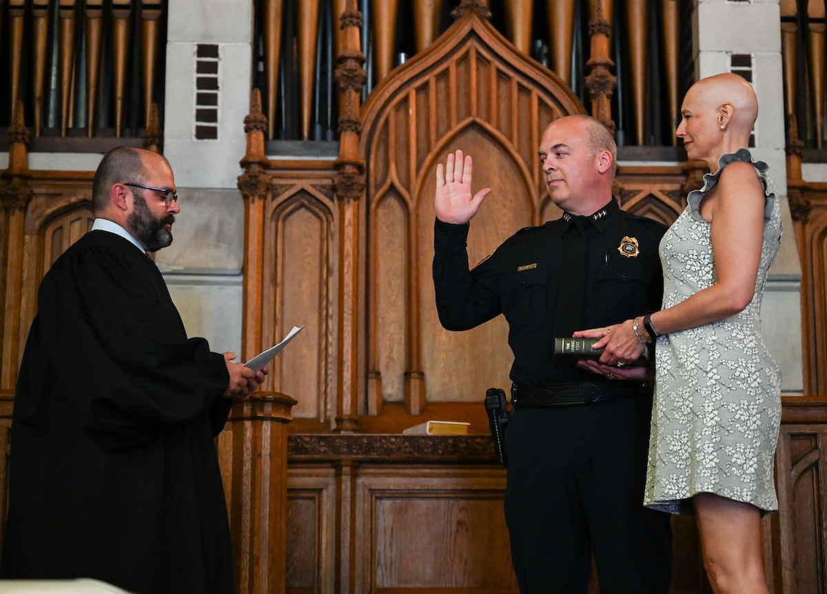Deputy Chief Matthew Holzmacher is sworn in by the Honorable Travis R. McDonough, chief judge of the U.S. District Court for the Eastern District of Tennessee, on Friday, May 10, in Patten Chapel. The bible holder was Holzmacher’s wife, Mandy. Photo by Noah Camacho.