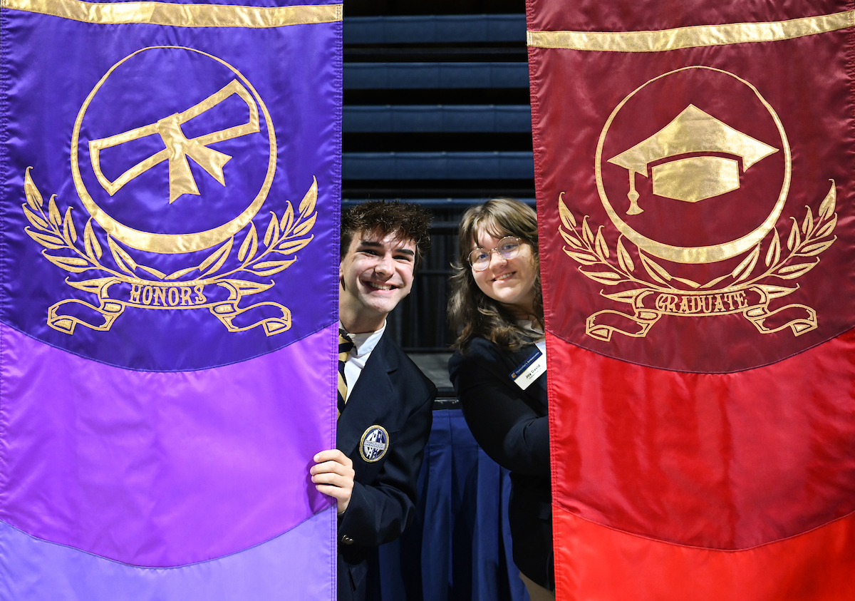 Chancellor's Ambassadors Braden Stillwell, left, and Joy David carried gonfalons as part of the UTC commencement processional during all three ceremonies.