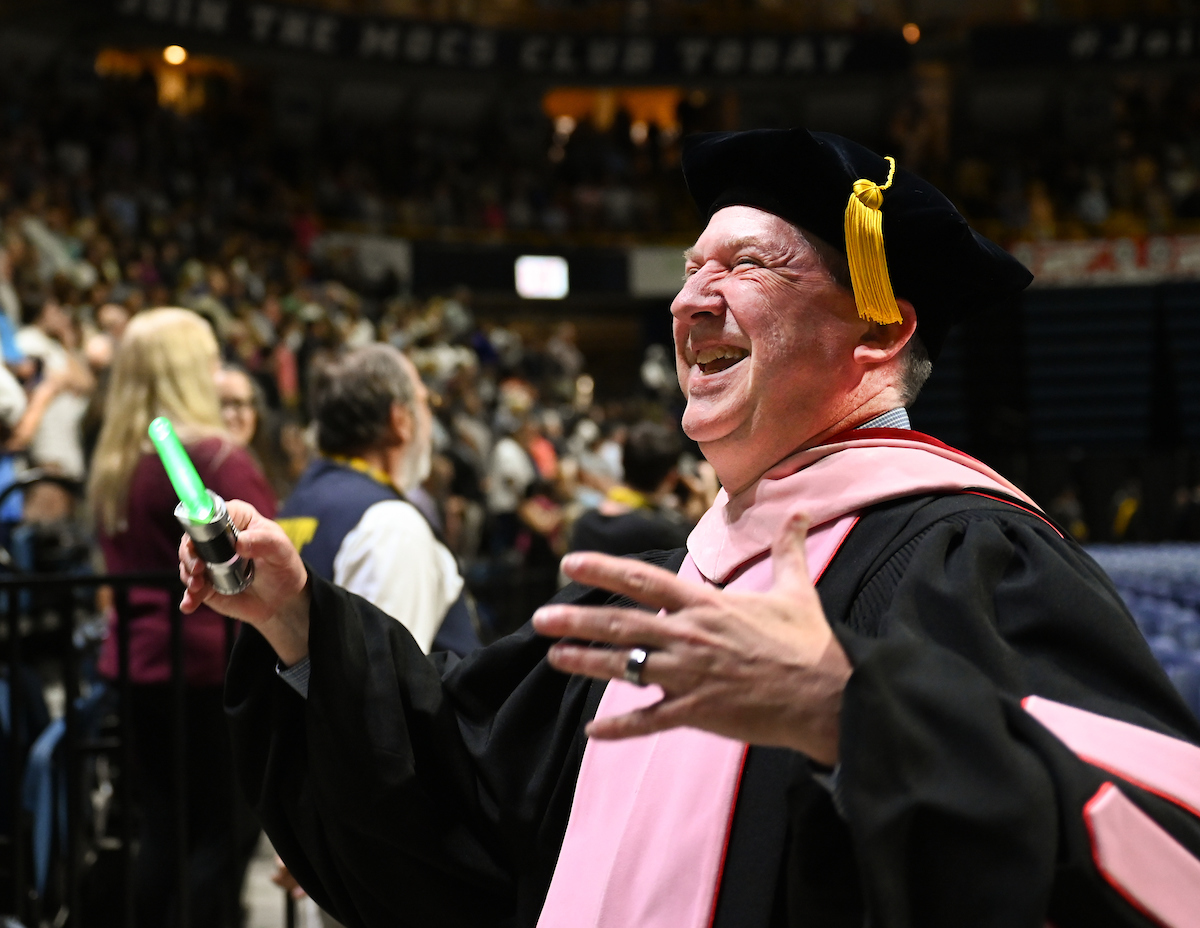 Dr. Kenyon Wilson, brandishing a miniature lightsaber, directs the "Imperial March."