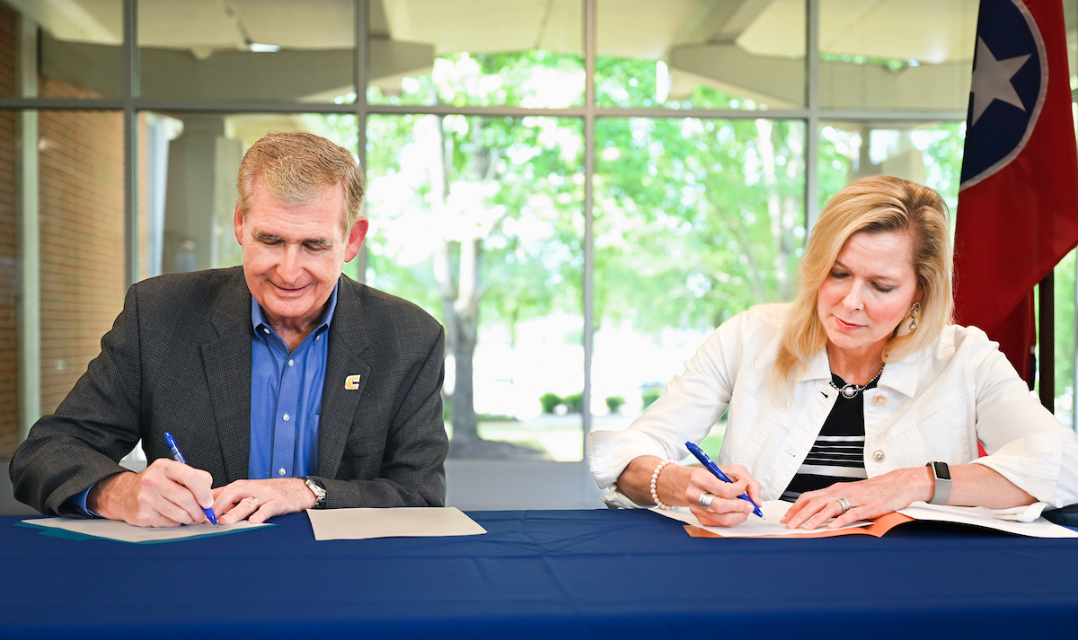 UTC Chancellor Steven R. Angle, left, and Chattanooga State Community College President Rebecca Ashford sign the associate to bachelor’s environmental science transfer agreement on June 21, 2024, in the ChattState Omniplex Building. Photo by Angela Foster.