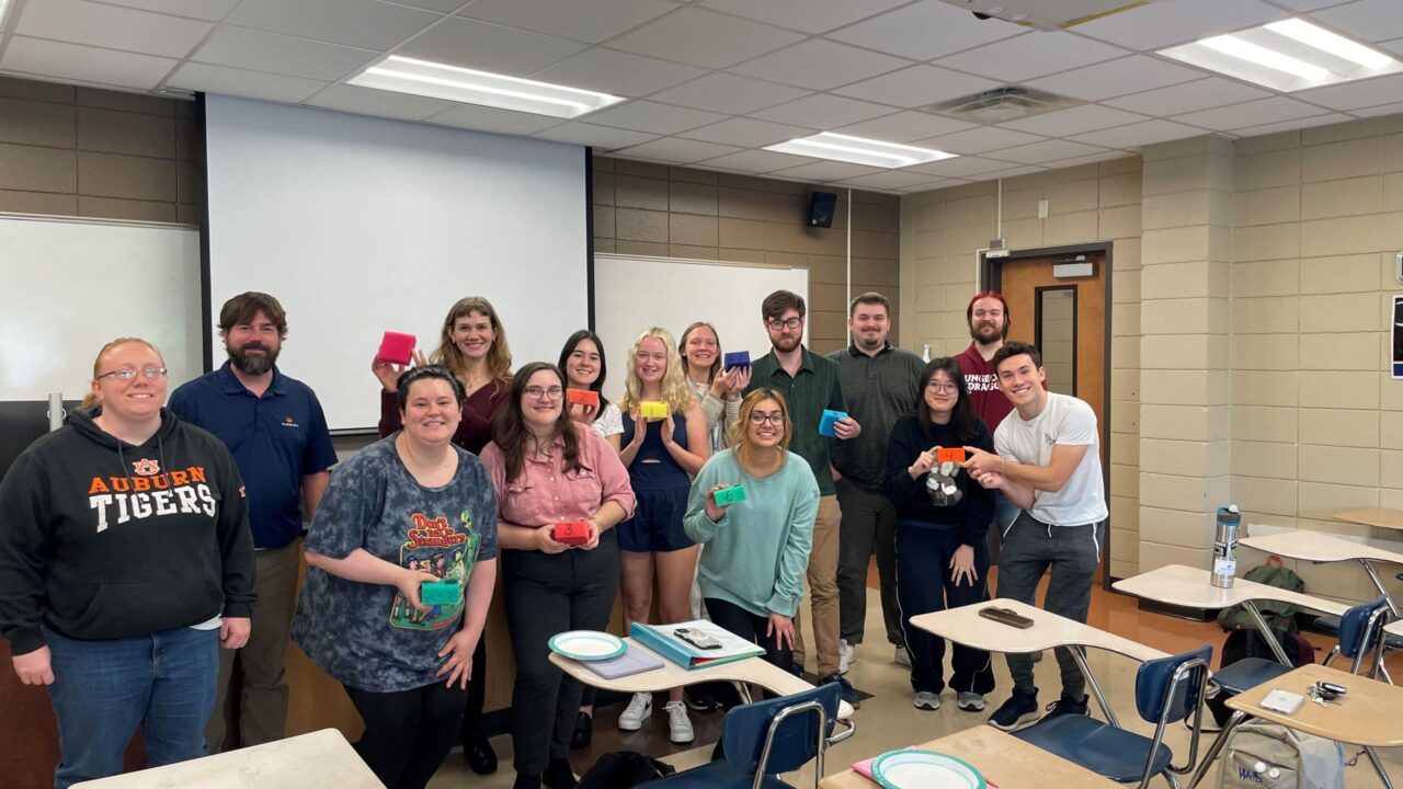 The polymer chemistry class after presenting their work to Kaitlyn Cathers (far left) and Carlisle Glover (second to left). The students are holding foam blocks made from the polymers they characterized at UTC.