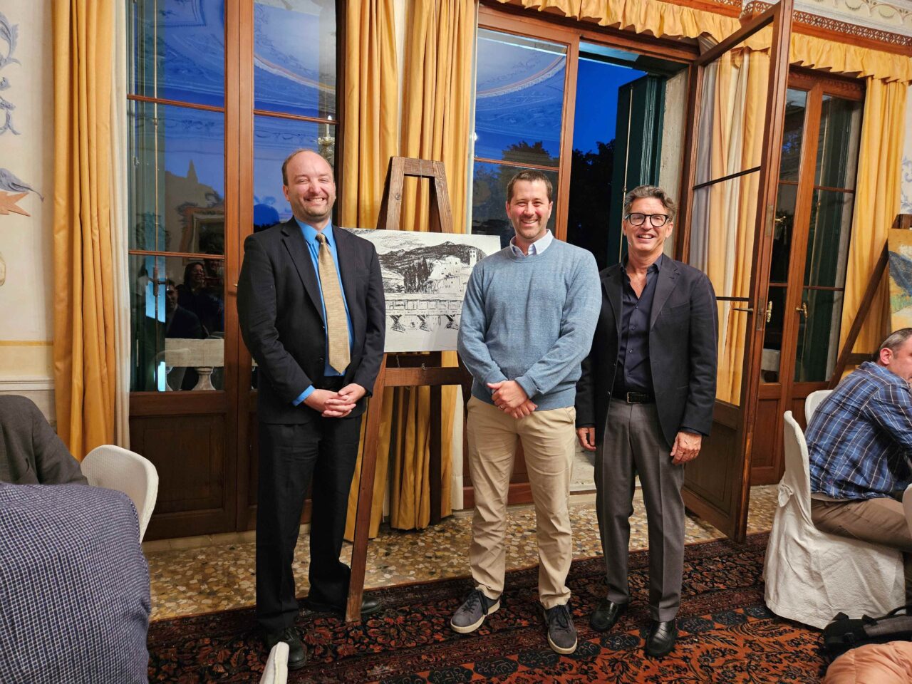 Dr. Aaron Shaheen (middle) stands between John Dos Passos Coggin (left) and Dr. Alberto Luca, the current owner of the Villa Ca' Erizzo Luca in Bassano del Grappa, Italy, during the John Dos Passos Conference. Photo courtesy of Dr. Aaron Shaheen.