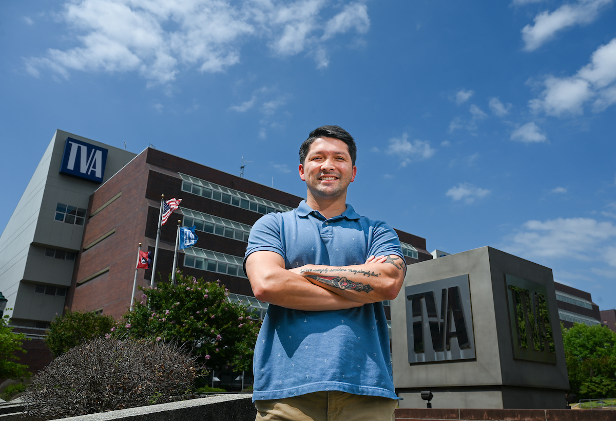 Justin Domon stands outside of TVA, where he works as an intern. He was a student in UTC's Bachelor of Applied Science: Information Technology in Cybersecurity (BAS-IT CyS) program. Photo by Angela Foster.
