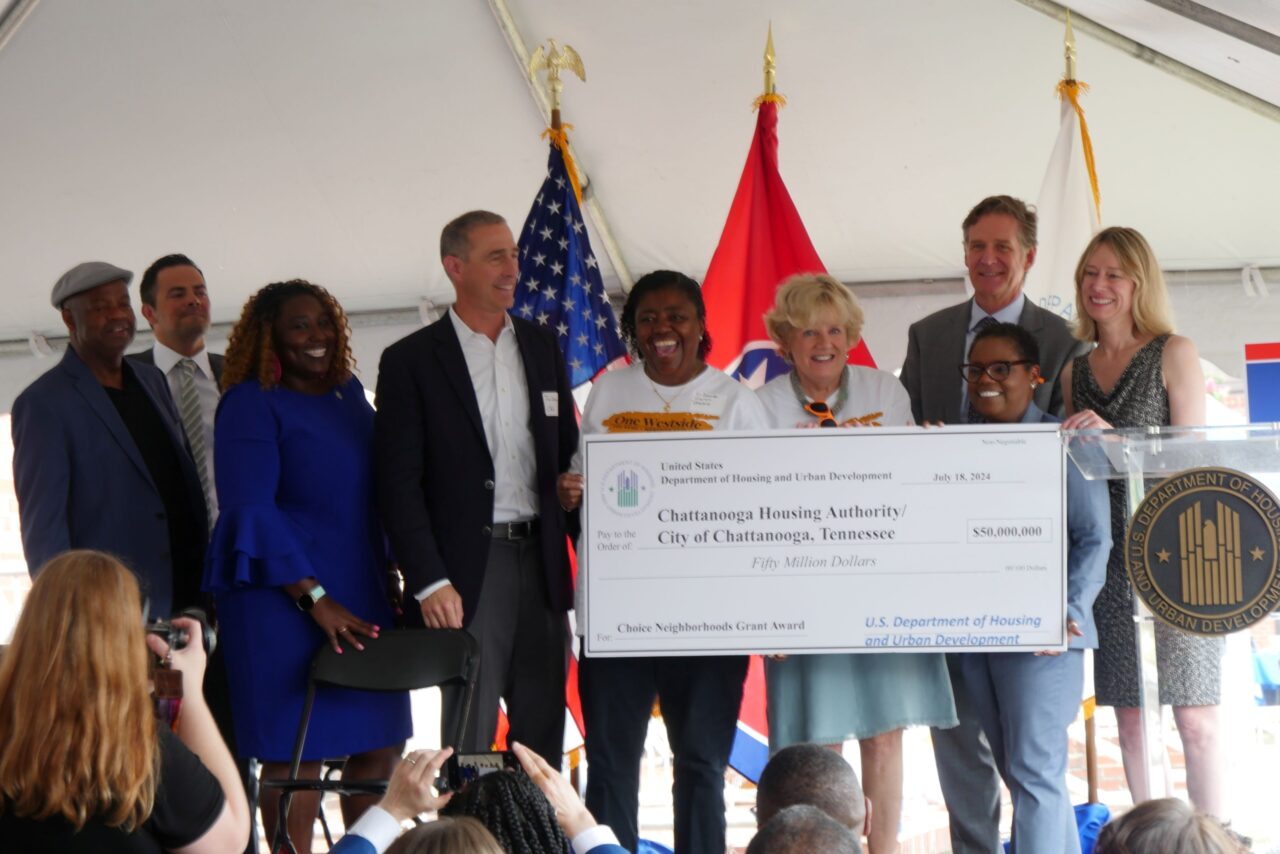 The ceremonial $50 million check presentation at the July 18, 2024, celebration of the HUD Choice Neighborhoods Implementation grant award. From left: Hamilton County Commissioner Warren Mackey, Hamilton County Mayor Weston Wamp, Chattanooga City Council member Raquetta Dotley, Chattanooga Housing Authority Board of Commissioners chairperson Jim Levine, Westside One Community leader Cassandra Robinson, CHA Executive Director Betsy McCright, Chattanooga Mayor Tim Kelly and HUD Regional Administrator Jennifer Riley Collins and General Deputy Assistant Secretary Dominique Blom.