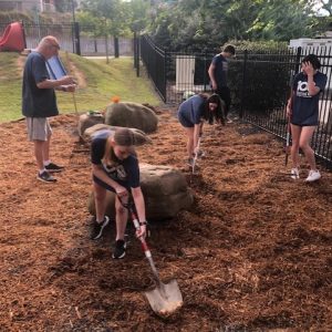 AdvanceU members doing landscaping work at Little Miss Mag as part of the 2023 United Way Day of Caring.