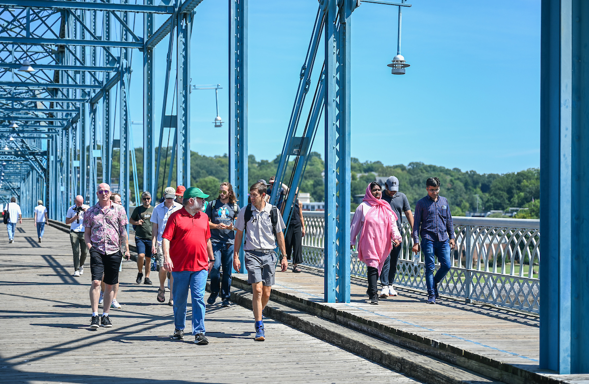 The new faculty tour crosses the Walnut Street Bridge. Photo by Angela Foster.
