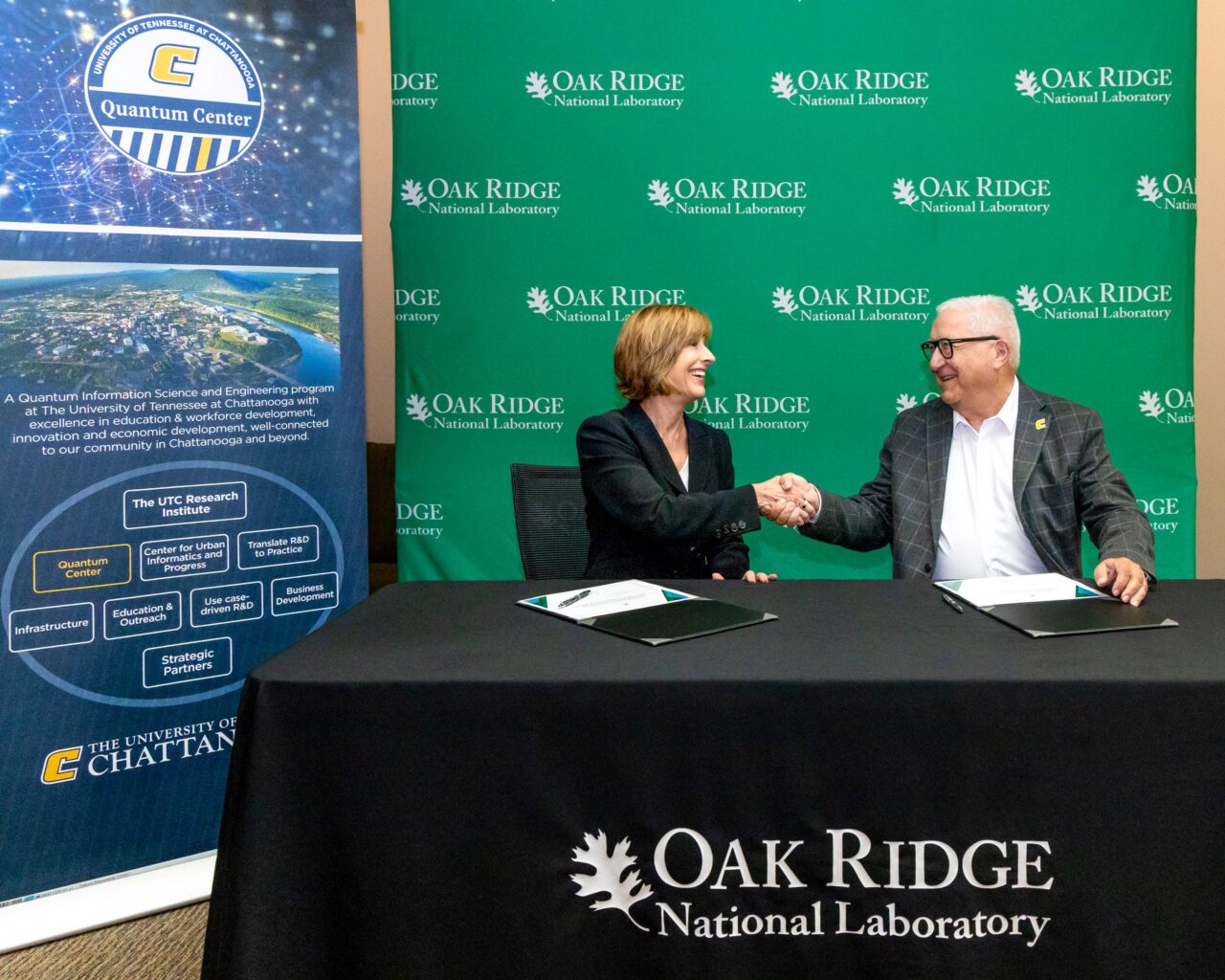 Oak Ridge National Laboratory Deputy for Science and Technology Susan Hubbard and UTC Vice Chancellor for Research Reinhold Mann shake hands after signing the memorandum of understanding agreement. Photo credit: Genevieve Martin/ORNL, U.S. Dept. of Energy.
