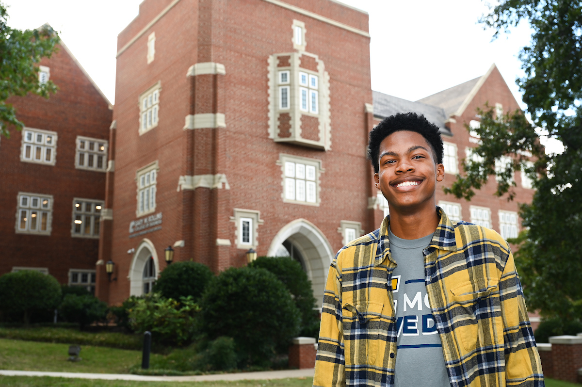 Joshua Clay in front of Fletcher Hall. Photo by Angela Foster.