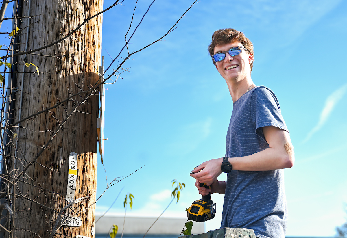Students in Chandra Ward’s Innovation in Honors class work Monday, Nov. 18, 2024 to put up tactical urbanism traffic calming installations in the Oak Grove neighborhood.