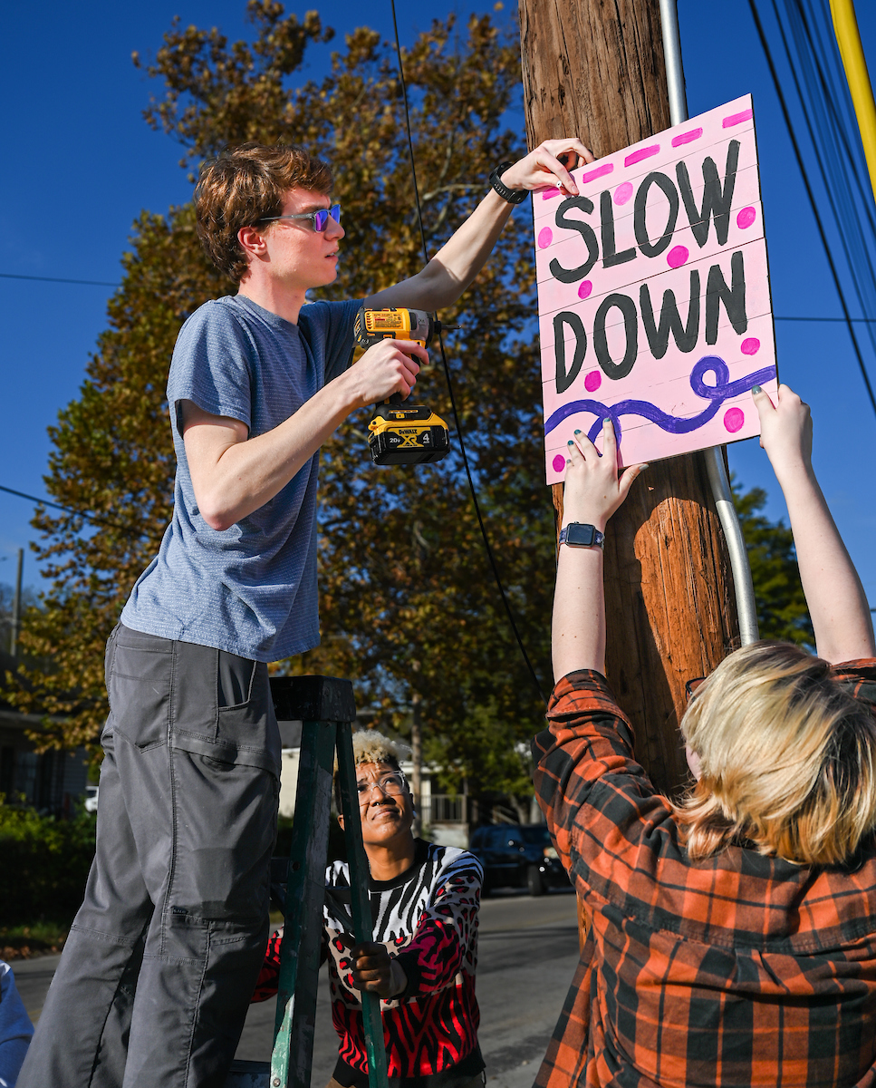 Students in Chandra Ward’s Innovation in Honors class work Monday, Nov. 18, 2024 to put up tactical urbanism traffic calming installations in the Oak Grove neighborhood.