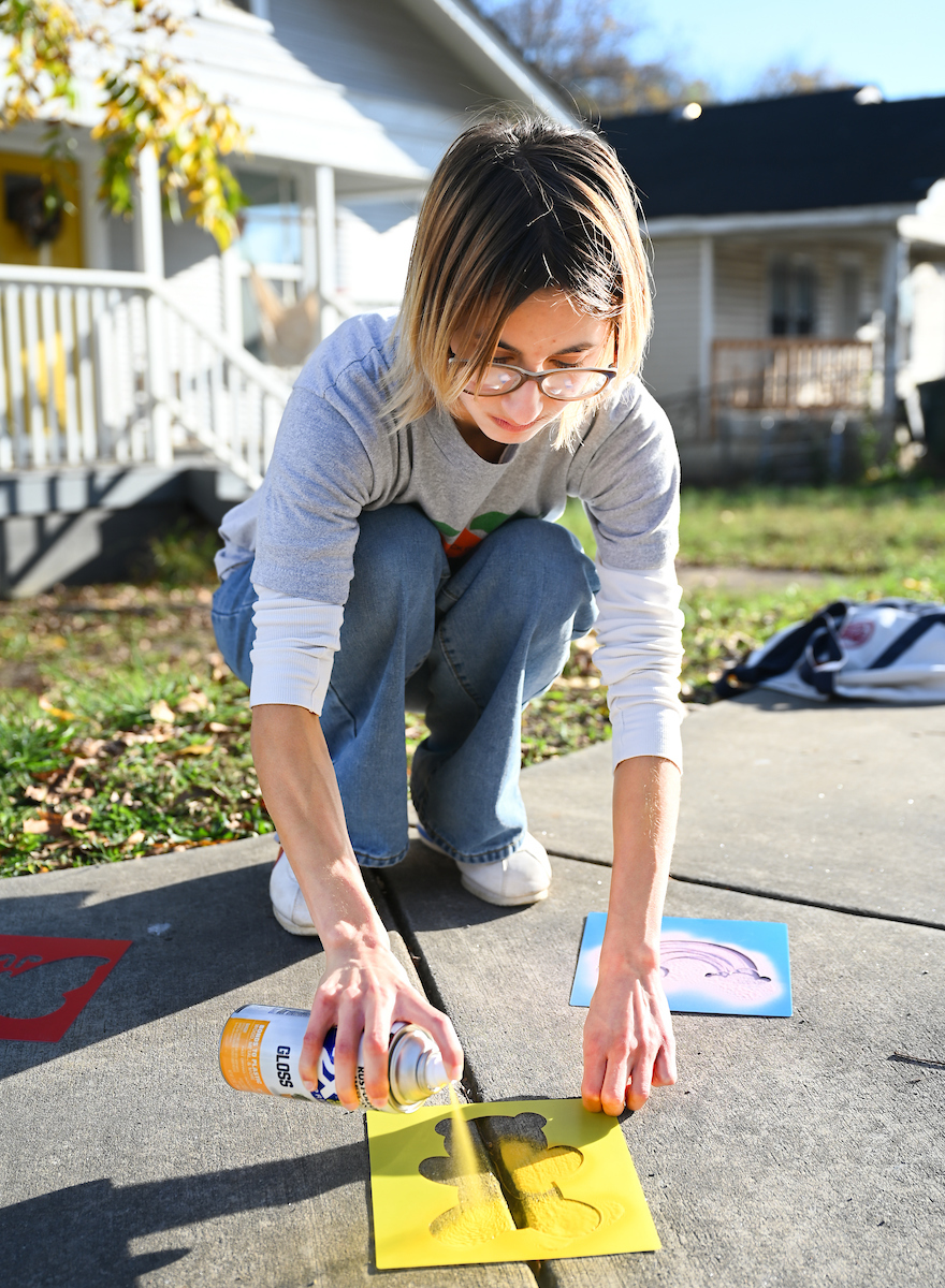 Students in Chandra Ward’s Innovation in Honors class work Monday, Nov. 18, 2024 to put up tactical urbanism traffic calming installations in the Oak Grove neighborhood.