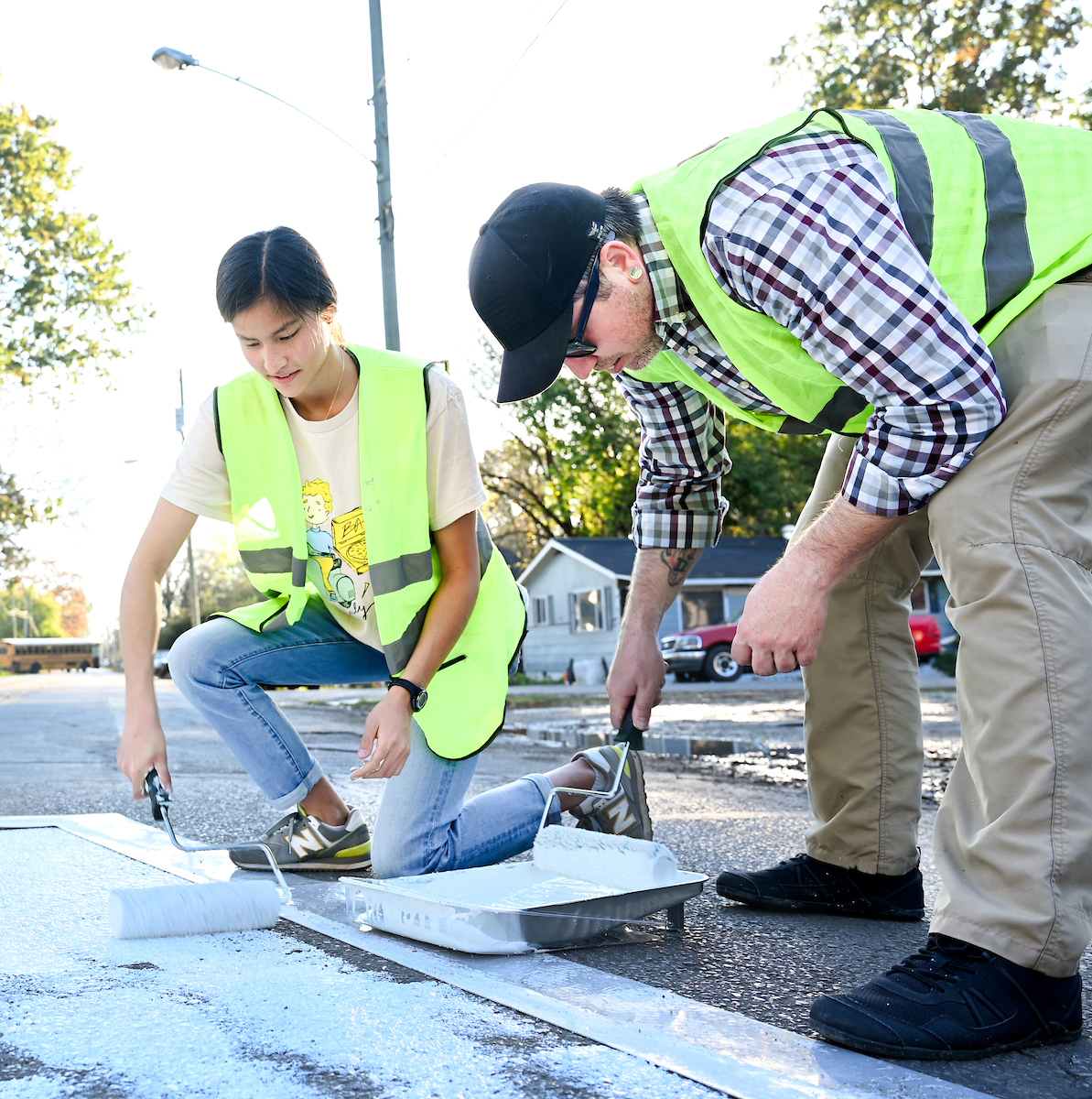 Students in Chandra Ward’s Innovation in Honors class work Monday, Nov. 18, 2024 to put up tactical urbanism traffic calming installations in the Oak Grove neighborhood.