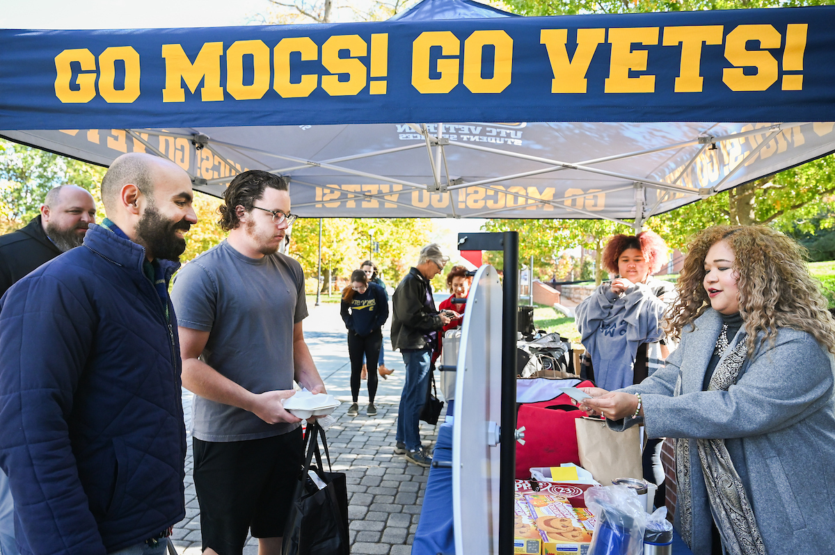 UTC Veteran and Military Affairs Director Sylvana Matthews, left, hands out food and prizes Thursday, Nov. 21, 2024, at Holiday for Heroes on the UTC campus. Photo by Angela Foster.