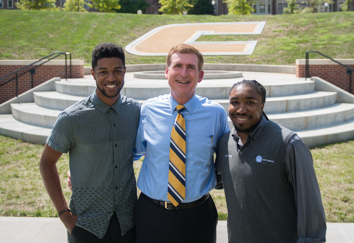 Chancellor Steve Angle with Robert Fisher, UTC's first Rhodes Scholar, and Nathan Harlan, the student who suggested the Chamberlain Field Power C and fire pit.