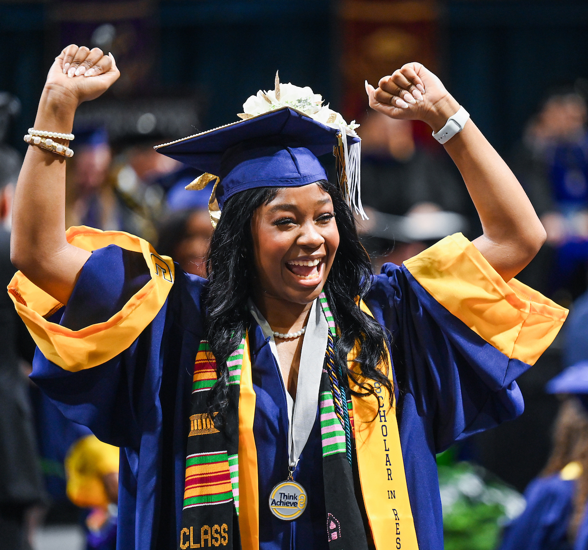 University of Tennessee at Chattanooga student Sherreda Peggs cheers as she walks back to her seat during the undergraduate graduation ceremony on Saturday, Dec. 14, 2024 in McKenzie Arena