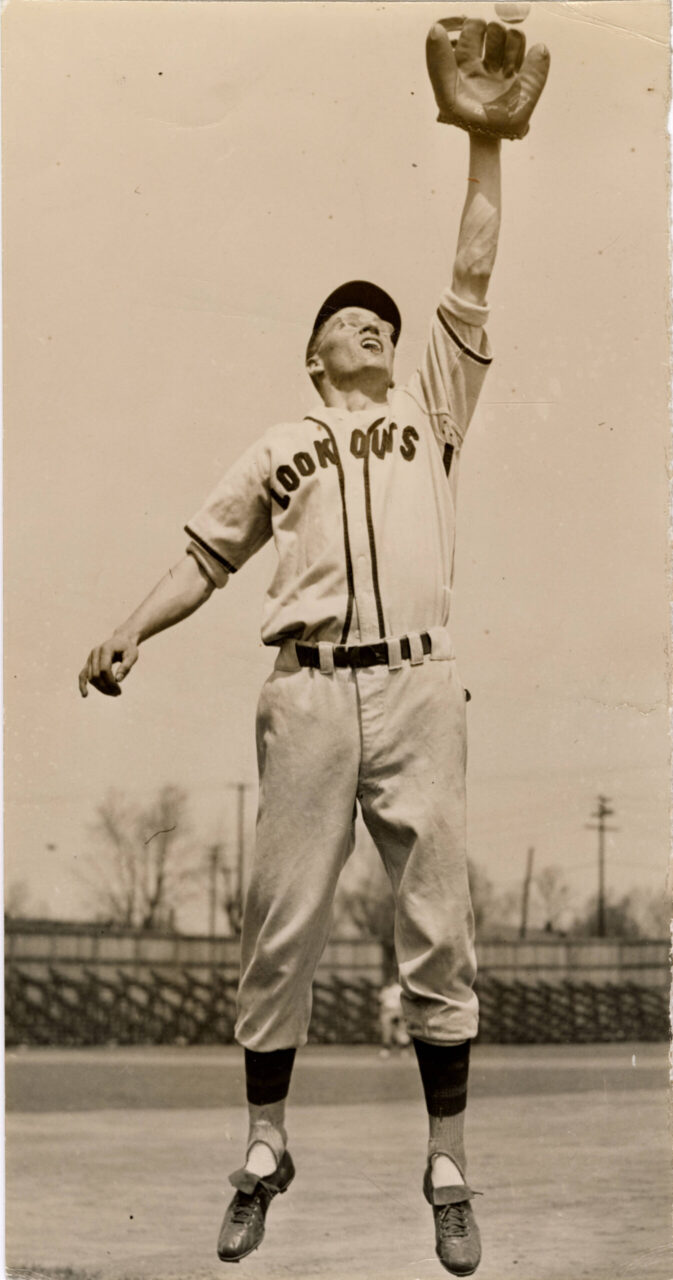 Black-and-white photograph of Lookout Al Kvasnak jumping to catch a ball.