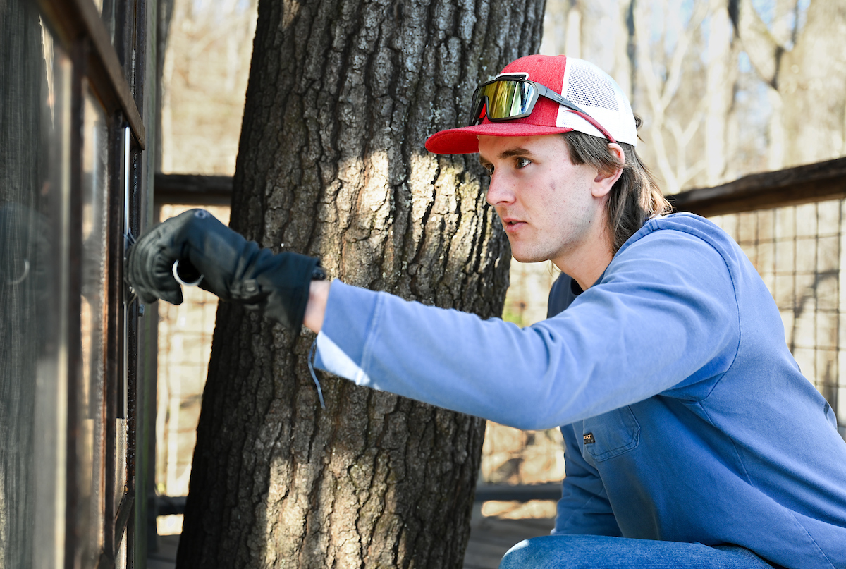 Gage Keeble washes windows on Tuesday, Jan. 14, at Treetop Hideaways at Ruby Falls. Photo by Angela Foster.
