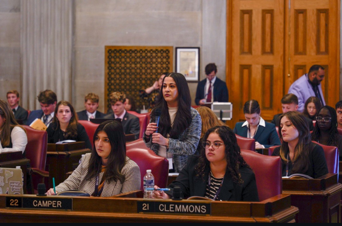 Beeta Baghaevaji (standing) defended her bills at the TISL mock legislature. Photo courtesy of Susanne Cooper.