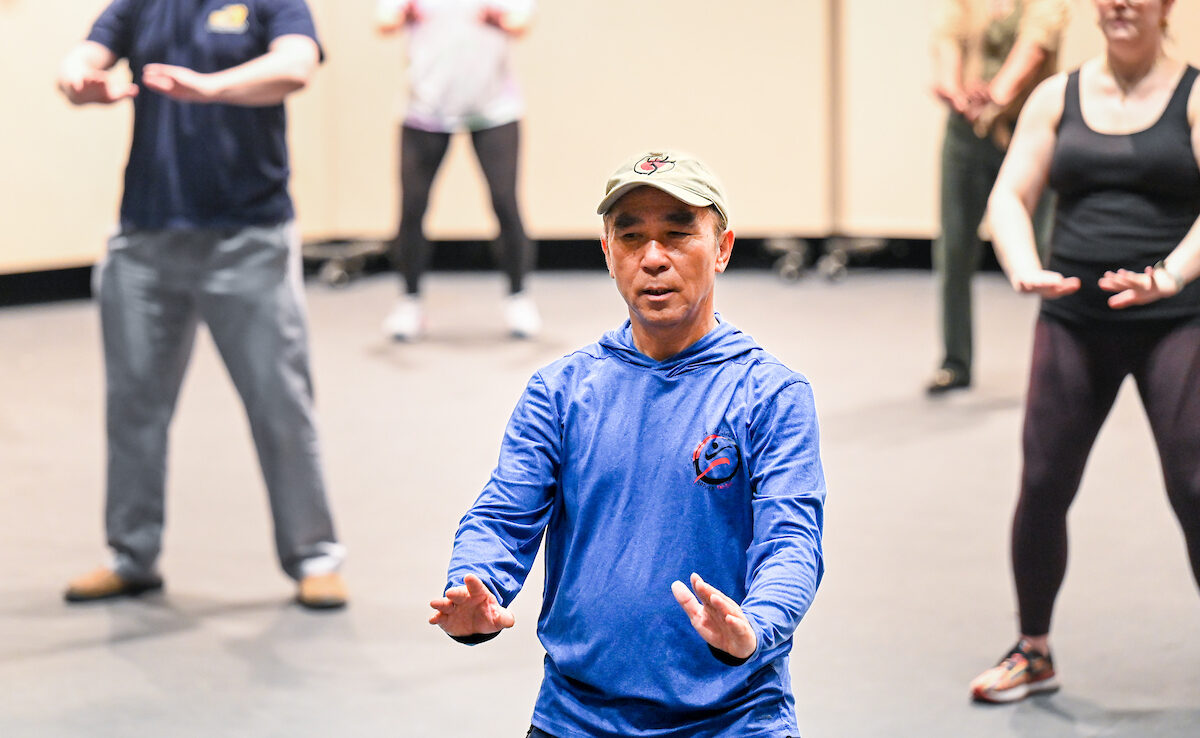 UC Foundation Professor of Medical Anthropology Zibin Guo began the Wheelchair/Adaptive Tai Chi program in 2016 to train health care workers to teach the smooth, fluid movements of the martial art to veterans with disabilities. Photo by Angela Foster.
