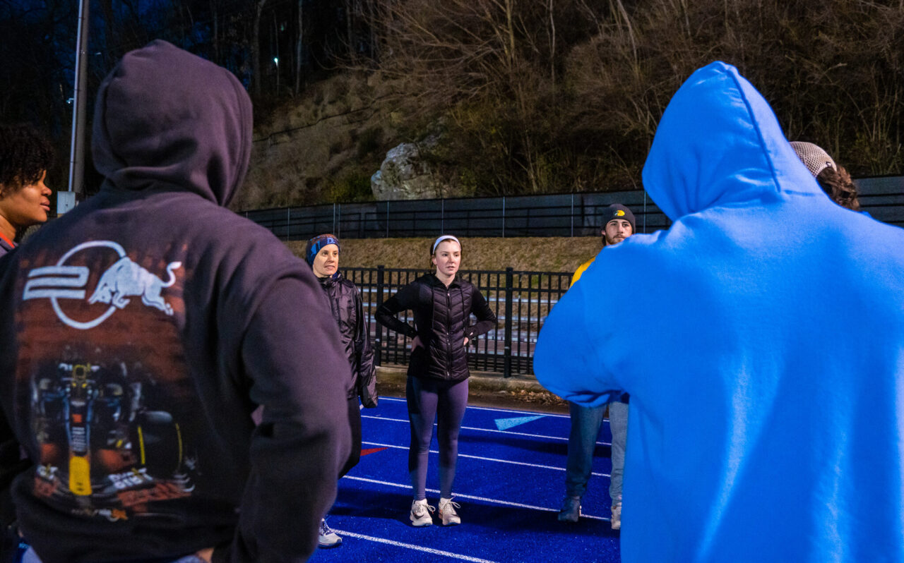Karissa Peyer (left) and Kathryn Brown listen to Alan Outlaw preparing the group for training.