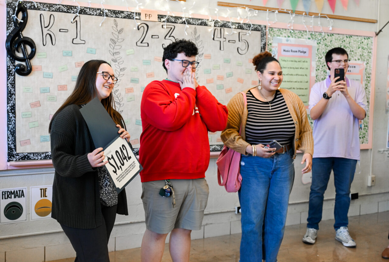 Music students and professor Alison Allerton deliver a $1000 check to Lauren Cardenas, music teacher and recent graduate, Friday, Feb. 28, 2025 at Dupont Elementary School.