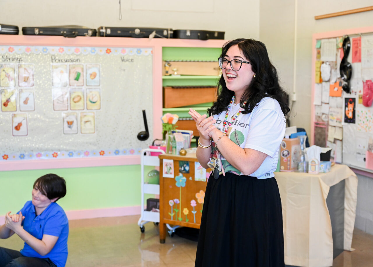 Music students and professor Alison Allerton deliver a $1000 check to Lauren Cardenas, music teacher and recent graduate, Friday, Feb. 28, 2025 at Dupont Elementary School.