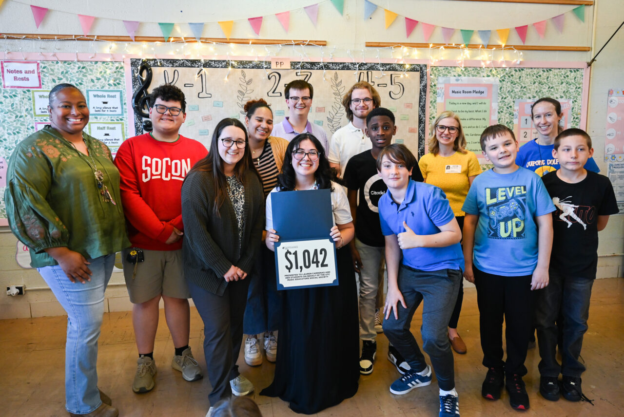 Music students and professor Alison Allerton deliver a $1000 check to Lauren Cardenas, music teacher and recent graduate, Friday, Feb. 28, 2025 at Dupont Elementary School.
